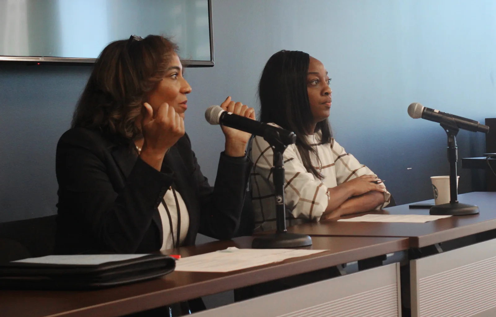 Two speakers seated at a panel table with microphones during the Nashville Bar Association CLE.